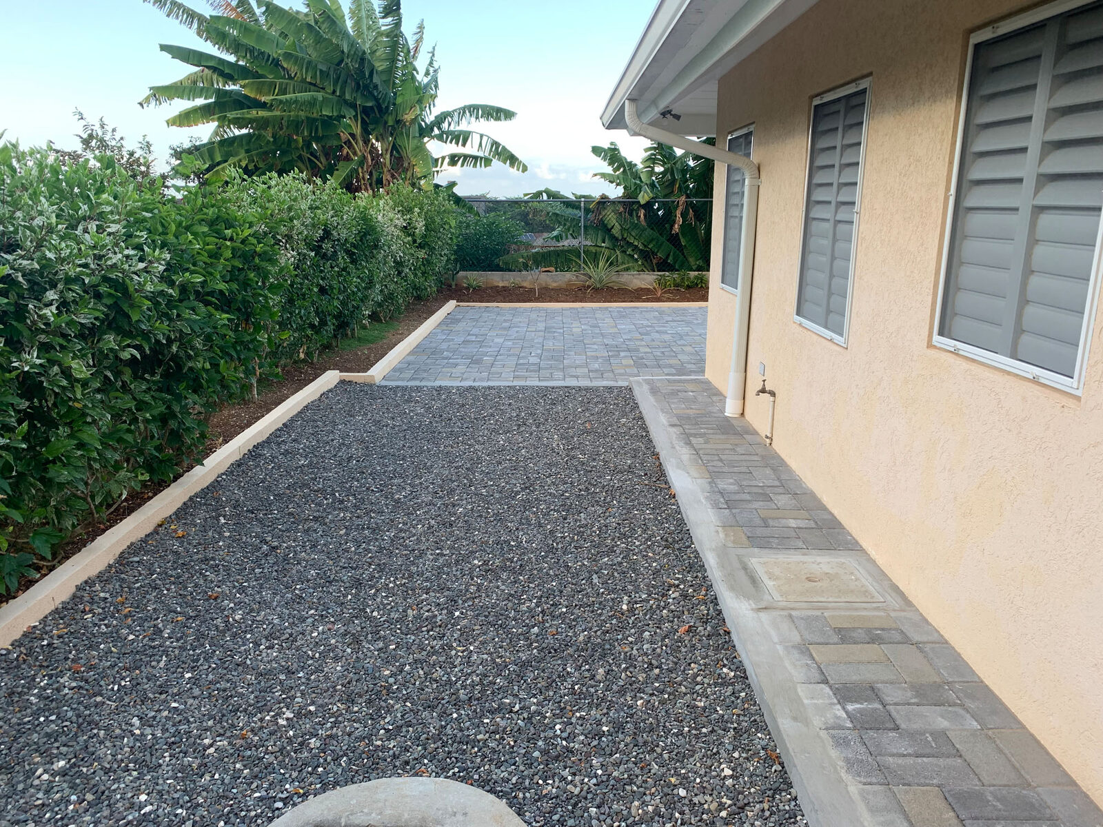 Completed gravel walkway beside residence
